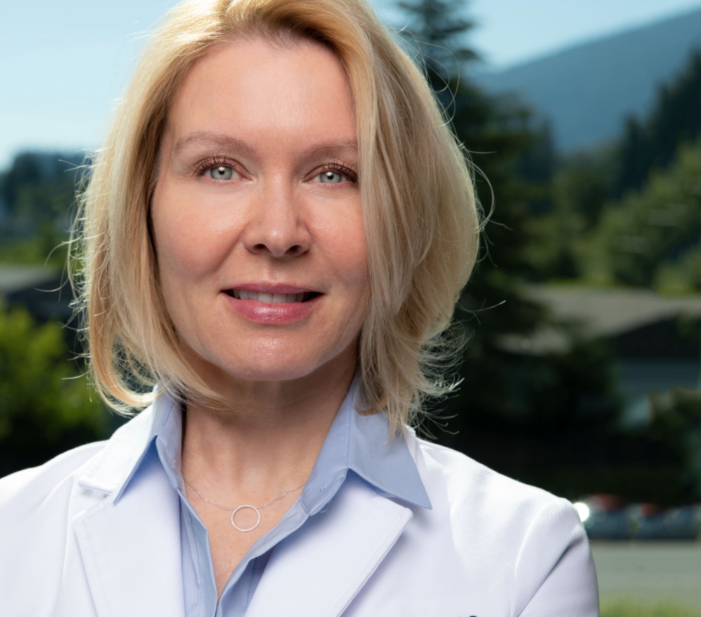 image example of a doctor's professional headshot with forest behind her
