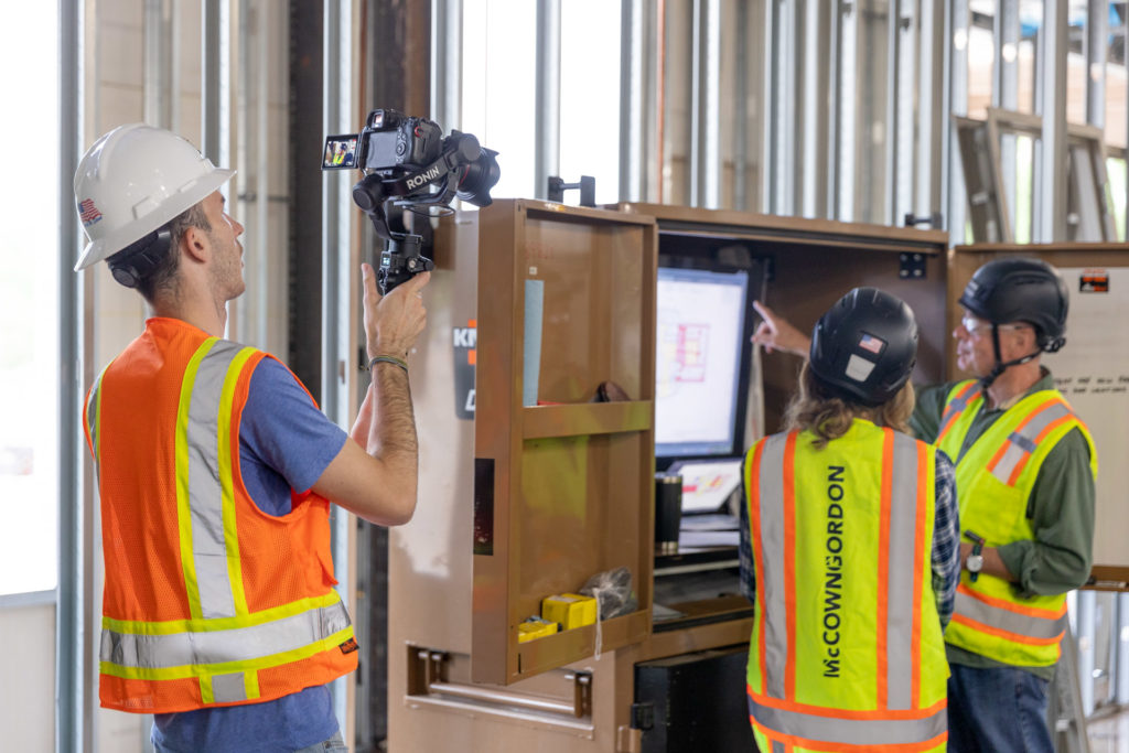 behind the scenes shot of a photographer on site shooting a construction worker, trying to improving your website roi with custom business photography from lifted logic web design