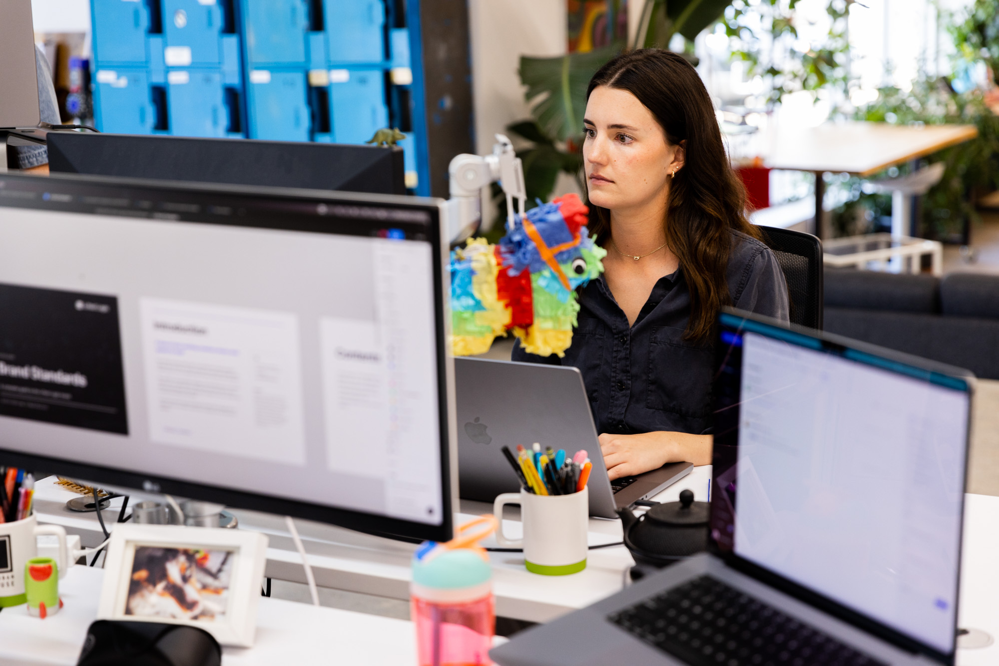 A female Lifted Logic web designer, wearing a black professional blouse, generates a reverse bid for a potential client using our web design pricing guide.