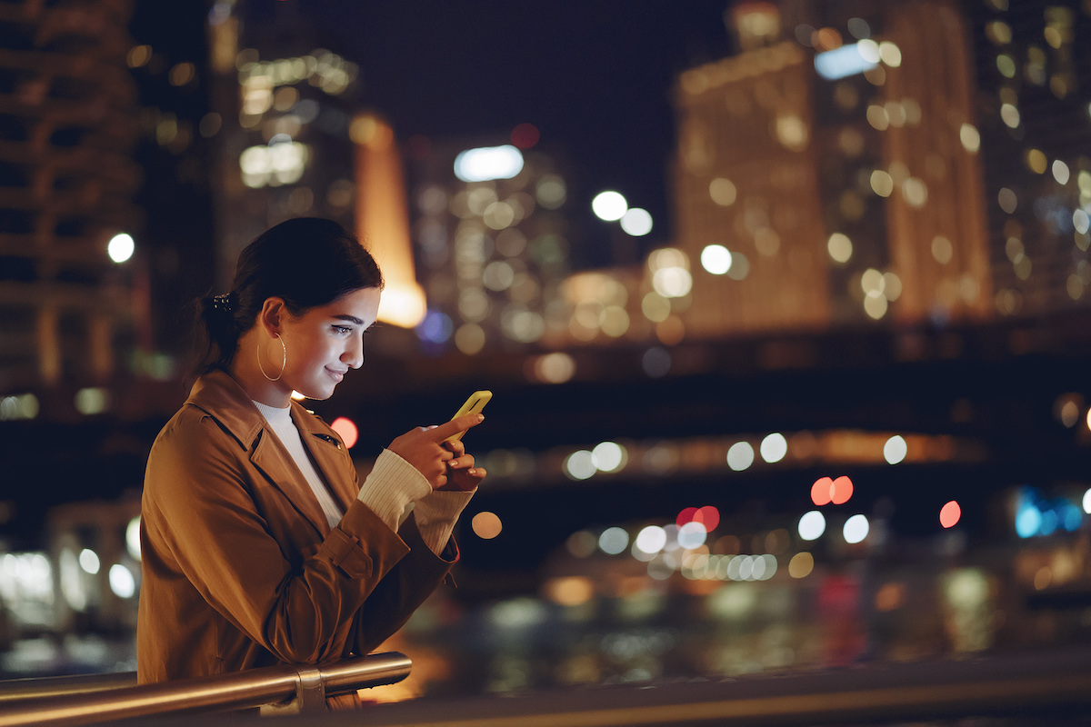 A woman talks with customer service on her phone after FreshSales integration.