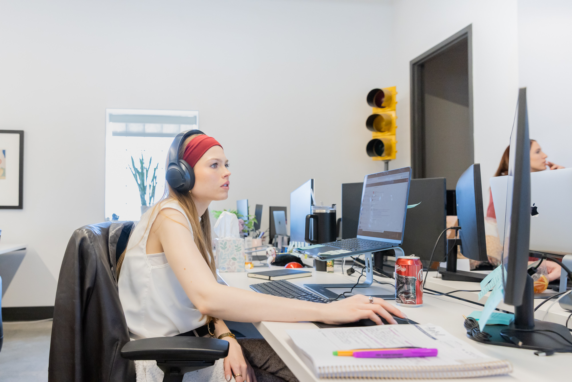 a strategist wearing headphones uses a computer to plan architecture company websites