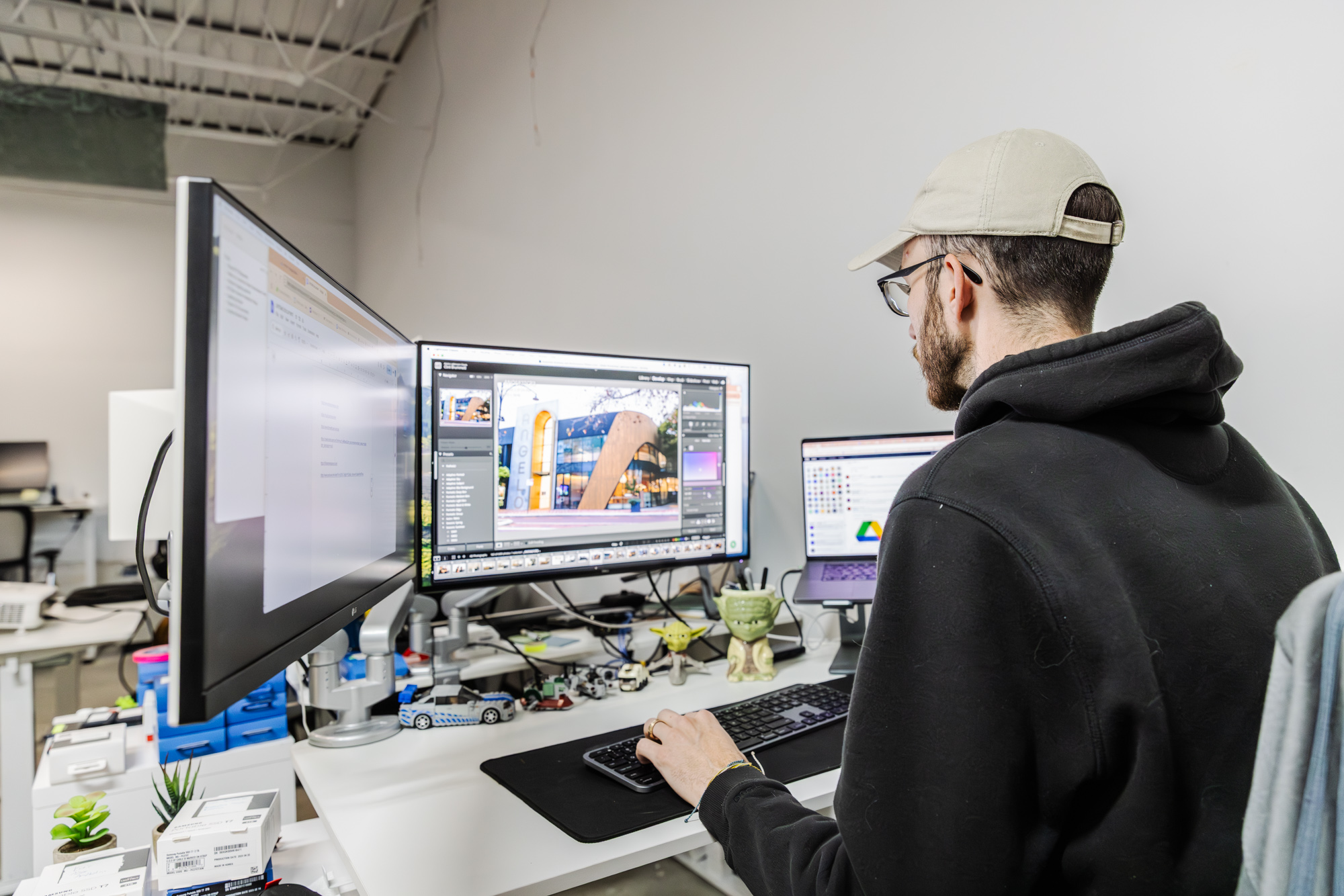 A web designer types on a computer while reviewing some of the best architect websites