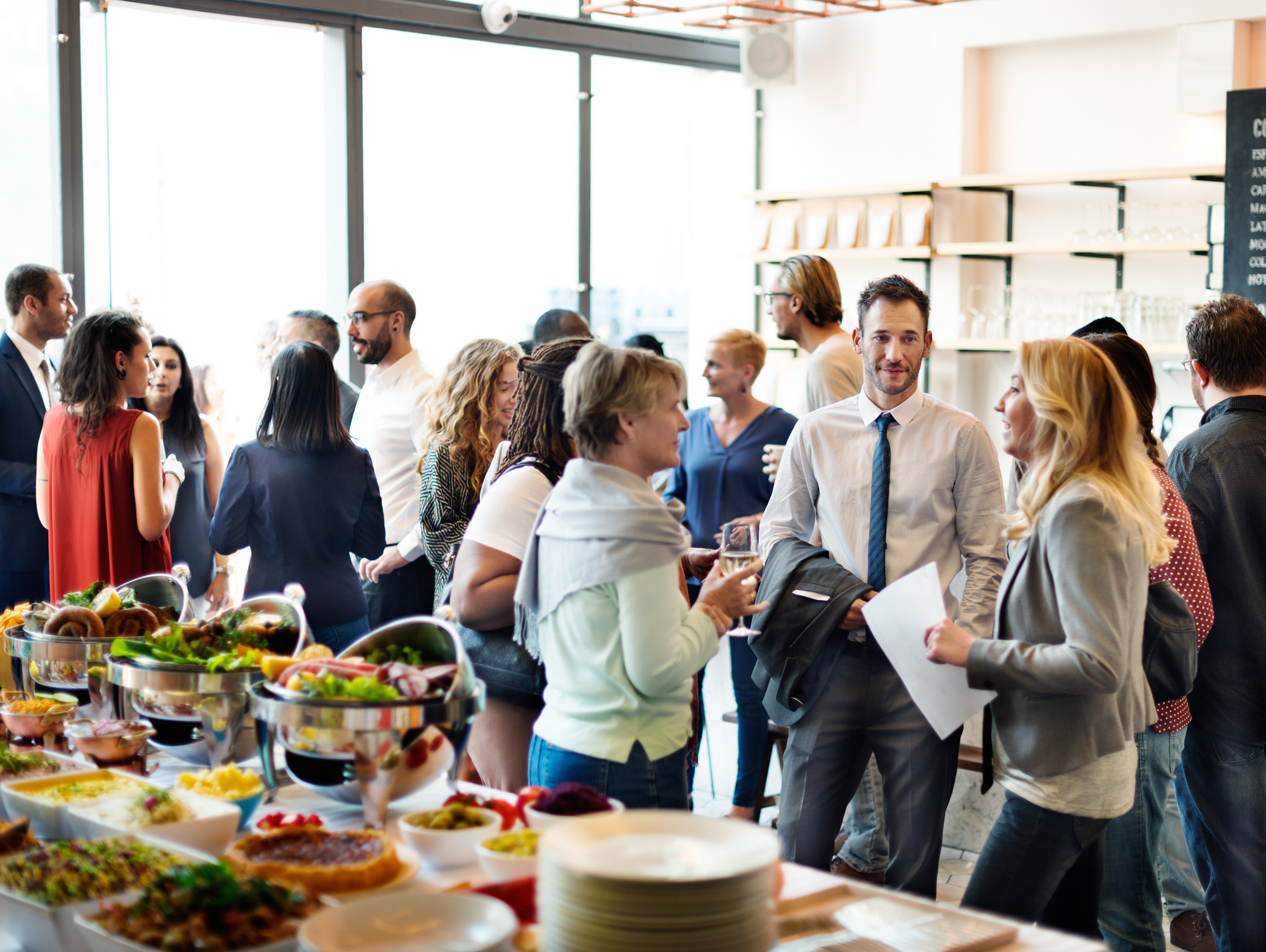 Group of people gathering for a buffet meeting.