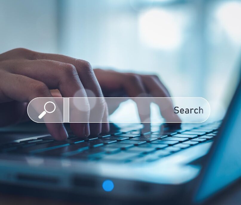 Person typing in their search query 'What is a SERP rank?'