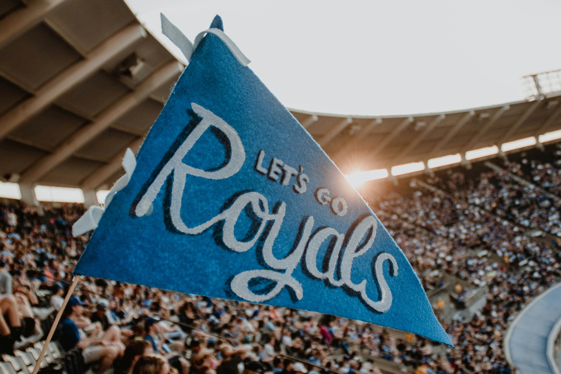 Fans at a stadium cheer for the Kansas City Royals in the summertime. Seasonal targeting benefits many Kansas City businesses as they build out SEO content calendars.